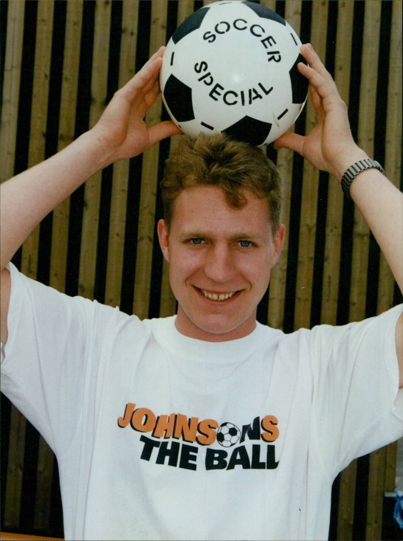 Johnson's Soccer special Adrian Johnson models the new t-shirt design. - Vintage Photograph