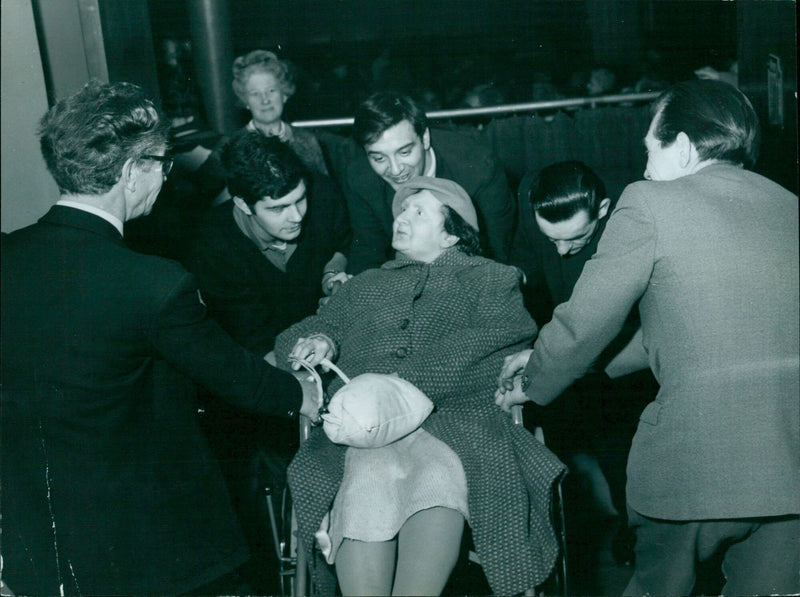 Mrs Roseana Harris is helped down the ramp into the new theatre. - Vintage Photograph