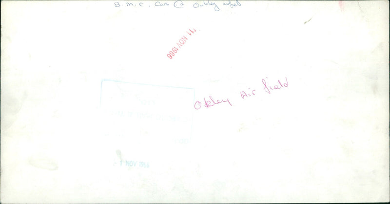 A helicopter flying over a military base on Laley Okley Air field. - Vintage Photograph