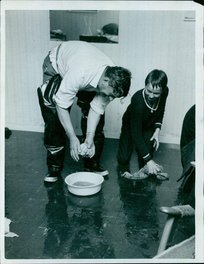 A family mops up after a flood in Oxford, England. - Vintage Photograph