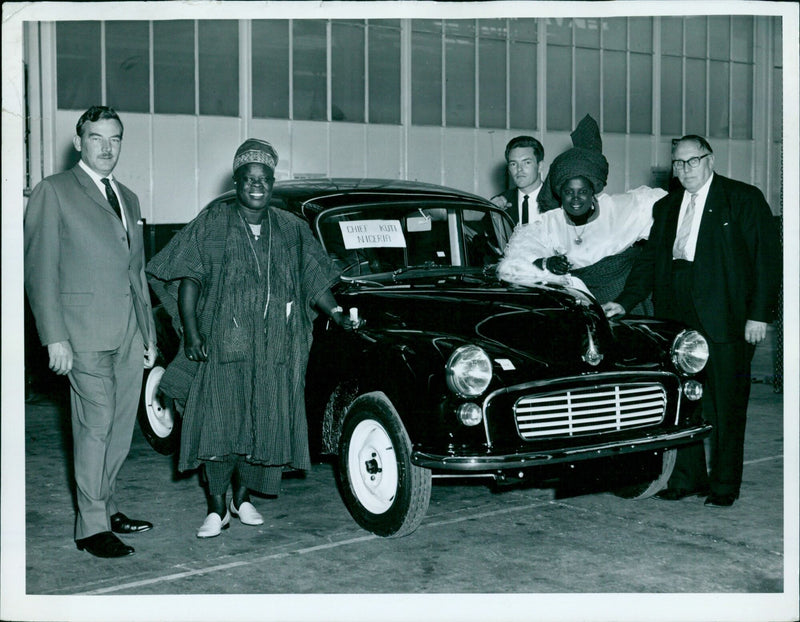 Chief Kuti Niceria inspects a newly-assembled Morris Minor. - Vintage Photograph