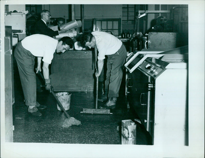 Two men are mapping out an operation in the Oxford University Press Lithography Plate Matin Department. - Vintage Photograph