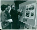 On display at the Pressed Steel Company in Cowley, three colleagues admire a prize-winning car design by Mr. C. R. Owen. - Vintage Photograph