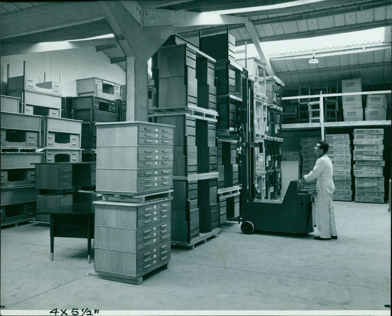 Employees of the steves department work at office tables. - Vintage Photograph