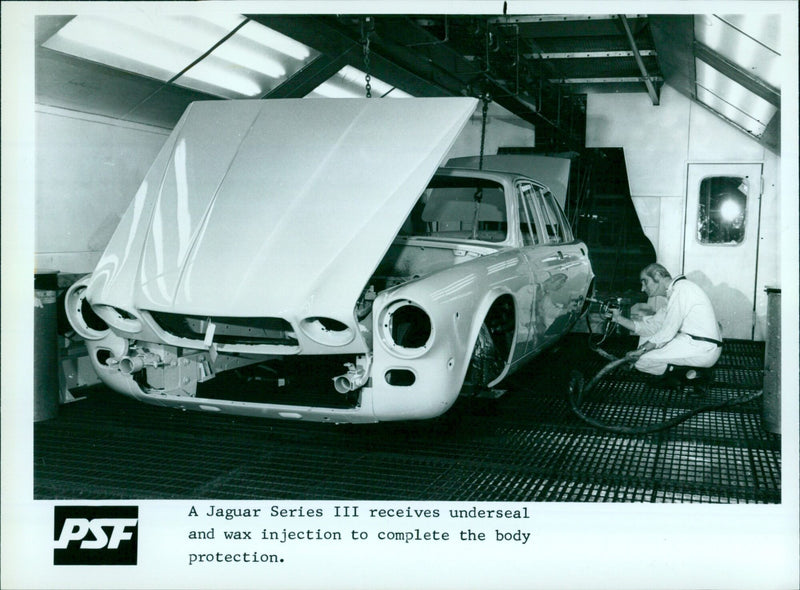 A Jaguar Series III undergoing body protection. - Vintage Photograph