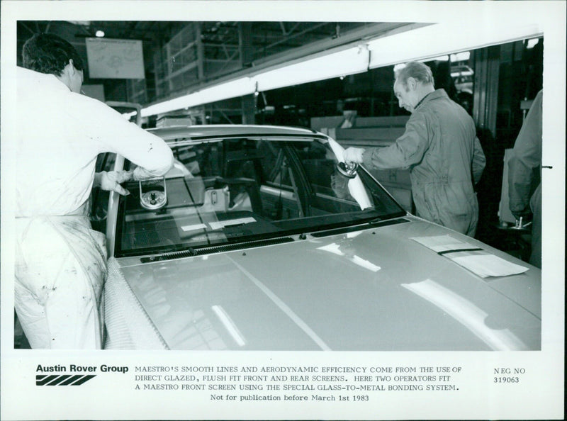 Two operators fit a Maestro front screen at the Austin Rover Group. - Vintage Photograph