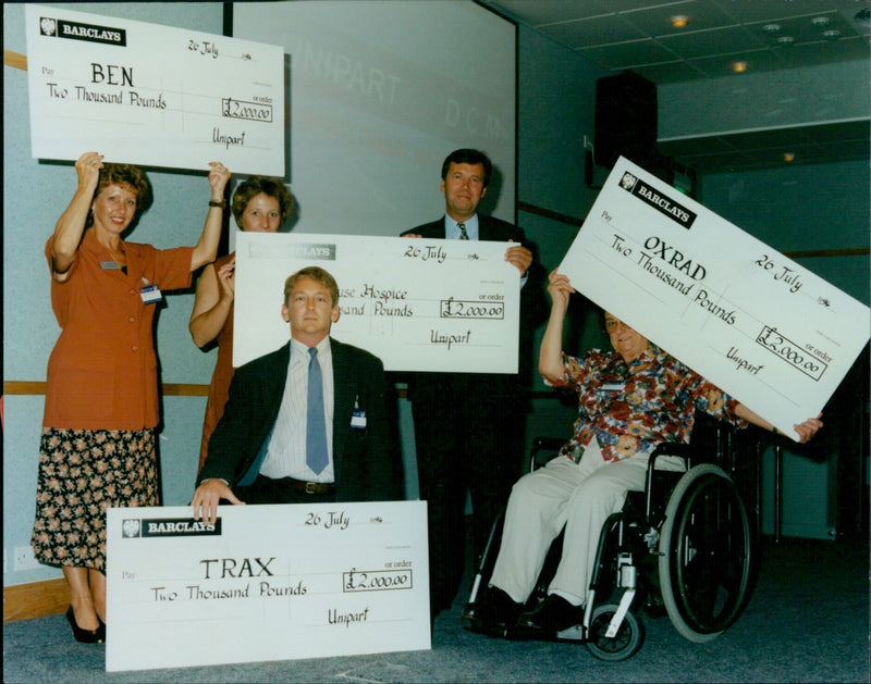 Representatives from BEN, Helen's House Hospice, Unipart DCM, OXSRAD and TRAX pose together at a gala event in Oxford, UK. - Vintage Photograph