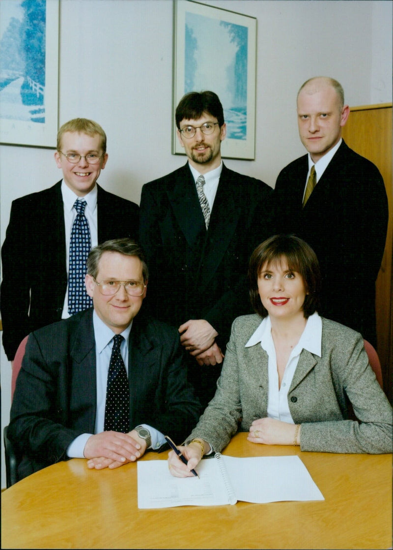 Representatives from Lifespan Healthcare NHS Trust and SureStock sign a new agreement. - Vintage Photograph