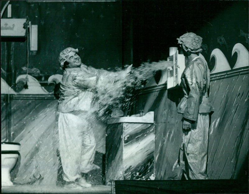 Actors Eddie Large and Syd "Supersonic" Little in Widow Twankey's Laundry during a pantomime performance. - Vintage Photograph