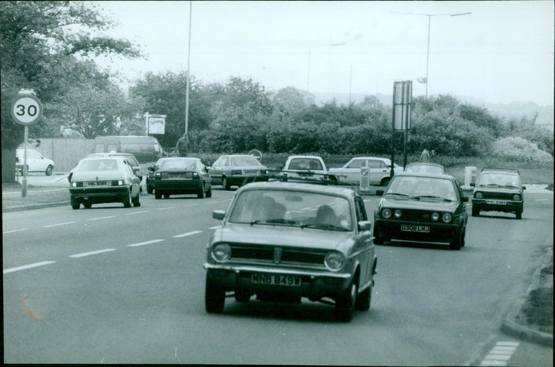 A roundabout in Oxford, England with a quid hanging from a street sign. - Vintage Photograph