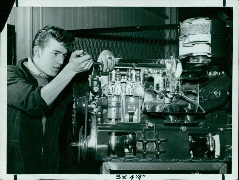 A group of apprentices from Morris Motor Company check the progress of a 3x4.4-meter engine block. - Vintage Photograph