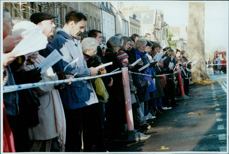 Service personnel and members of the public observe a two-minute silence during a Remembrance Day service in Oxford. - Vintage Photograph