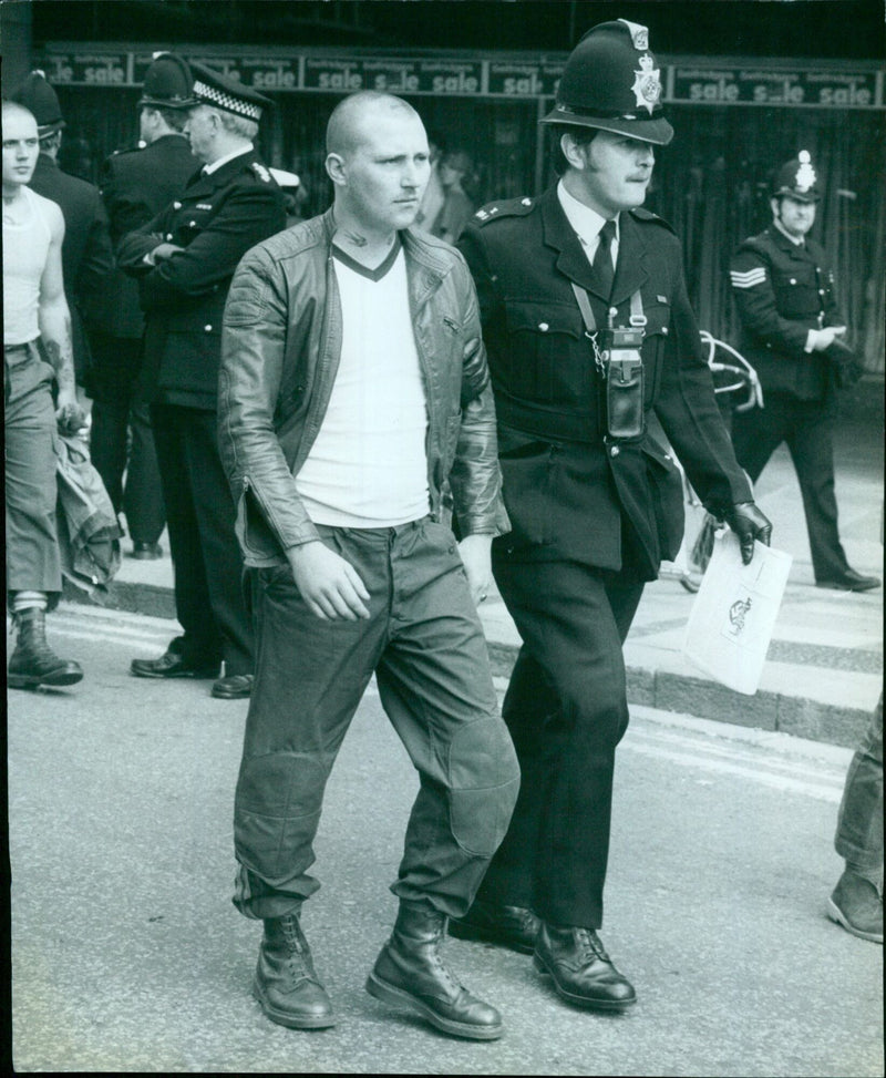 Police officers detain a protester at a demonstration in Madrid, Spain. - Vintage Photograph