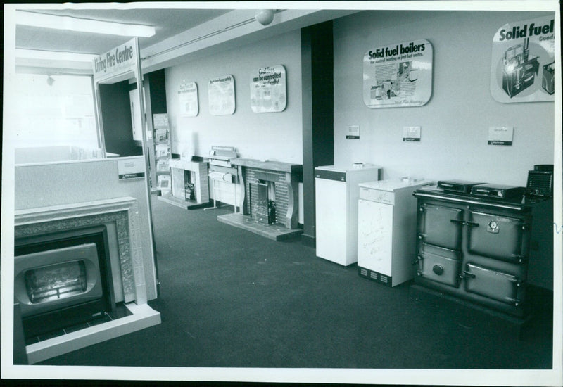 Homeowners learn to safely operate solid fuel boilers for central heating and hot water during a Living Fire Centre Open Fresh event. - Vintage Photograph