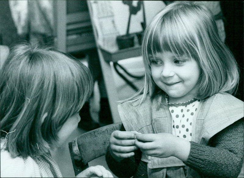 Charlotte Skriner shows two classmates a plant she has been growing. - Vintage Photograph