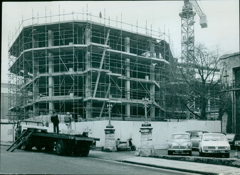 Construction workers build a new office building in Oxford, England. - Vintage Photograph