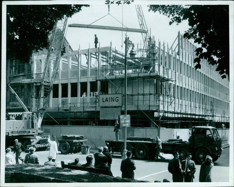 John Laing and his team of engineers unload equipment from a truck to a car park. - Vintage Photograph