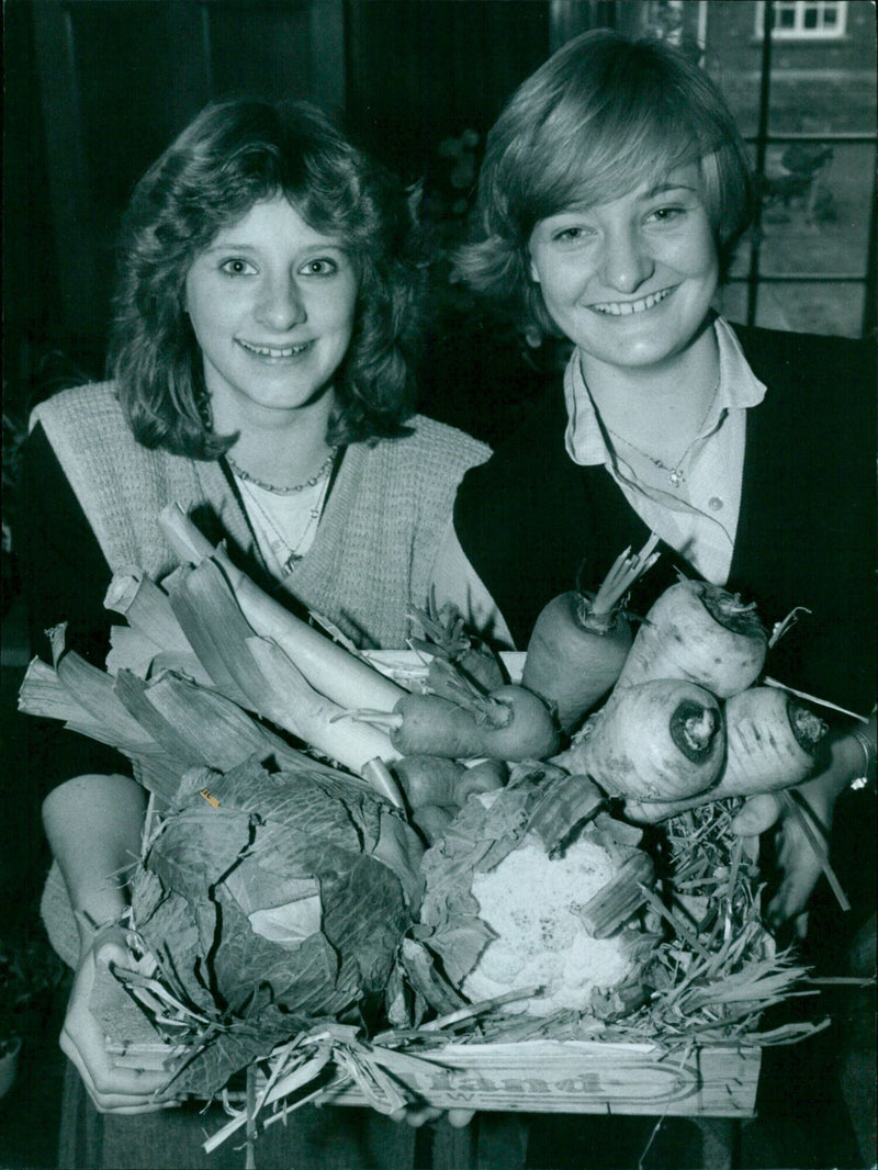 Teenagers Alison Finch and Helen Knowles showcase vegetables at the Headington School charity fair. - Vintage Photograph