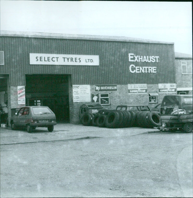 A customer selecting tyres from Select Tyres Ltd. - Vintage Photograph