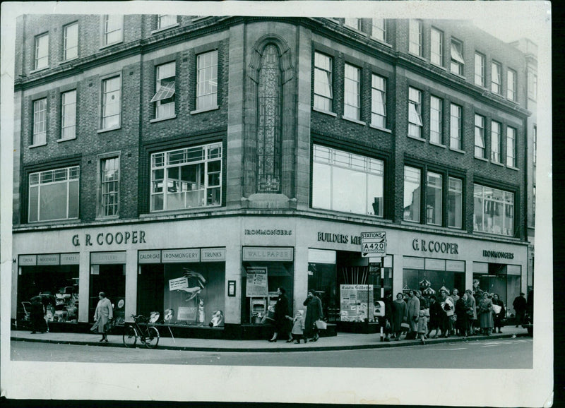 Customers examine items in the window of G.R. Cooper Ironmongers in Faringdon, England. - Vintage Photograph