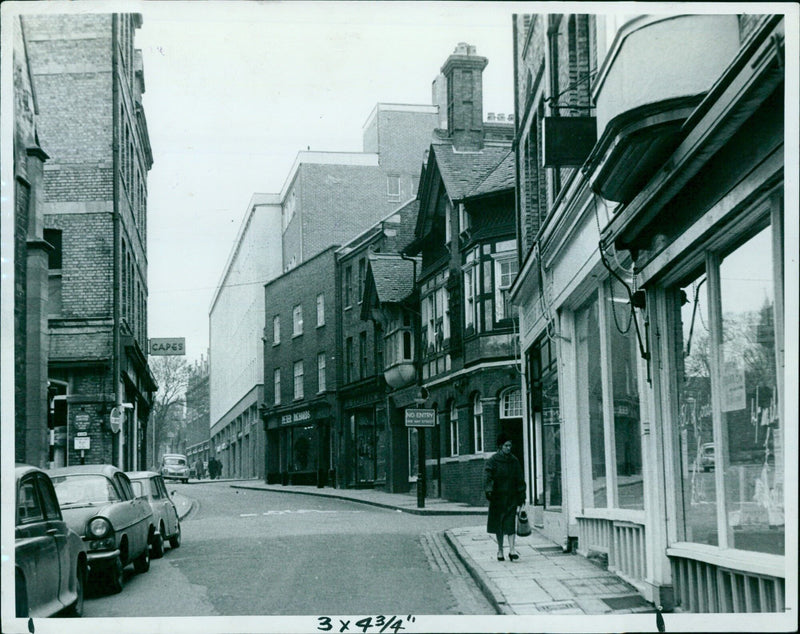 A street sign and its reflection in a puddle. - Vintage Photograph