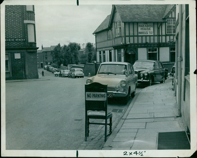 A sign outside the Paradise House Store reads "No Parking". - Vintage Photograph