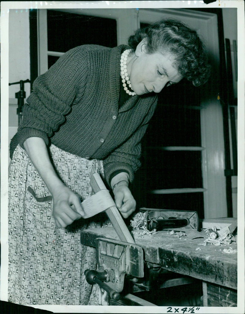 Miss M. E. Thomson sanding a leg of a coffee table. - Vintage Photograph