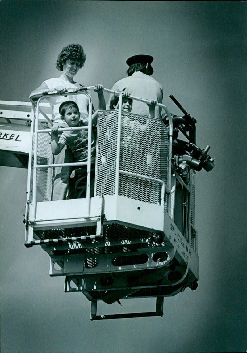 Firefighter observes a bay view from the fireman’s hoist. - Vintage Photograph