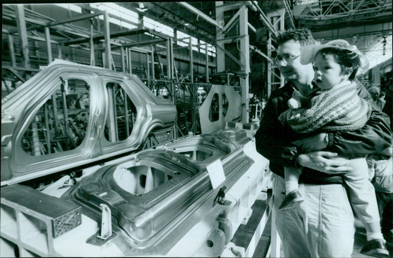 A father and son inspect a Rover 800 car at an Austin Rover Open Day. - Vintage Photograph