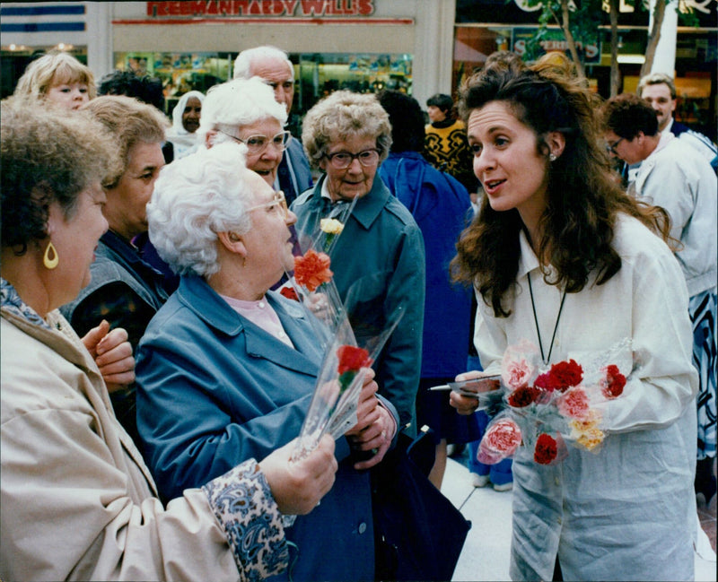 Helen Hobson from the musical My Fair Lady hands out flowers to kick off the Oxford in Bloom event. - Vintage Photograph