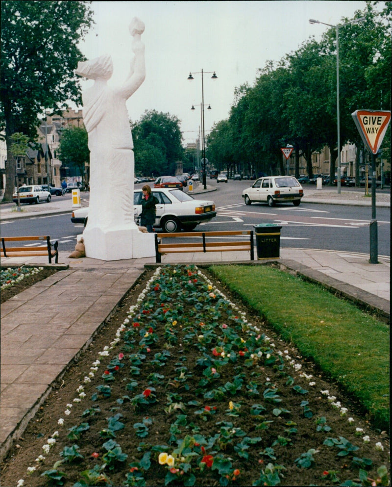 People move away from a Goddess of Liberty Statue in St. Giles, Oxford. - Vintage Photograph