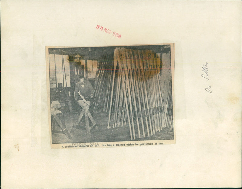 A craftsman shapes an oar with a trained eye for perfection. - Vintage Photograph