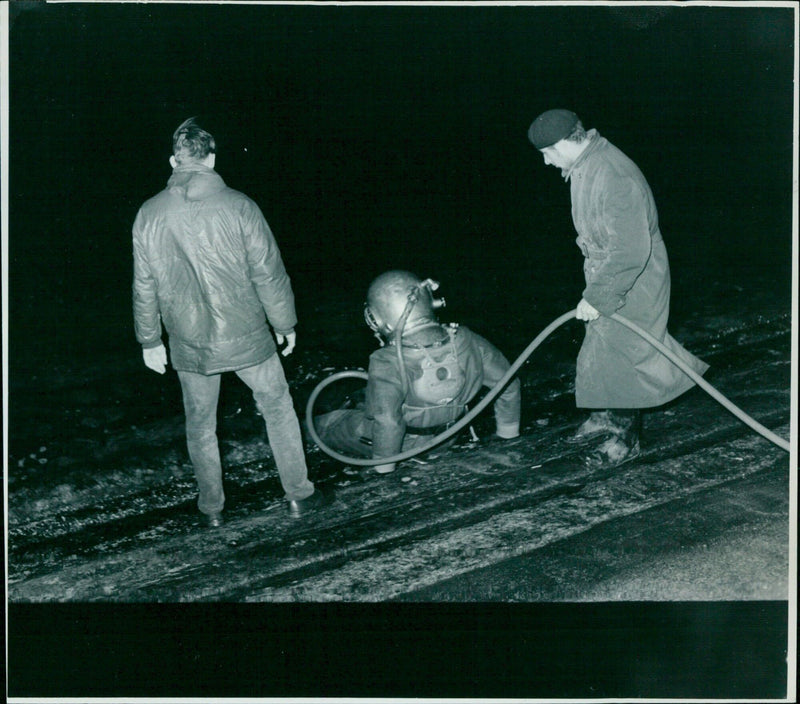 A deep sea diver descends into the depths of the John Hedgesun Famor Resevors. - Vintage Photograph