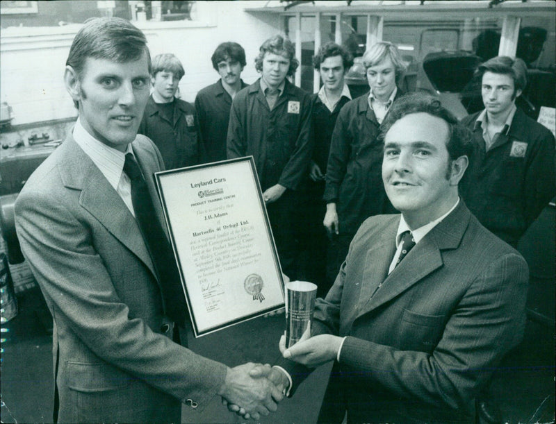 John Adams of Hartwells of Oxford Ltd. receives an award from Leyland Cars Service consultant Roger Chalwin. - Vintage Photograph