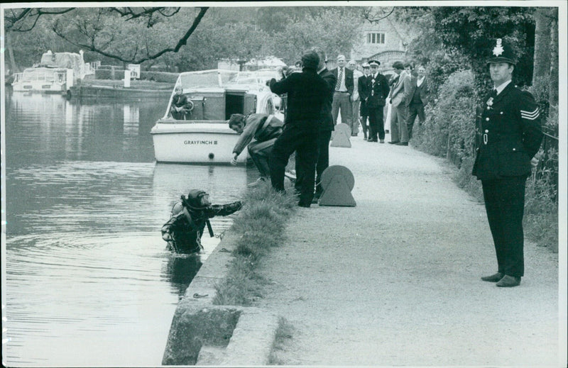 Police search for clues near the spot where the missing boy was found. - Vintage Photograph