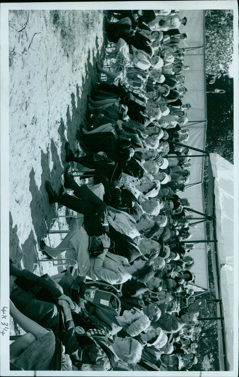 A crowd gathers to watch a parade in an unknown location. - Vintage Photograph