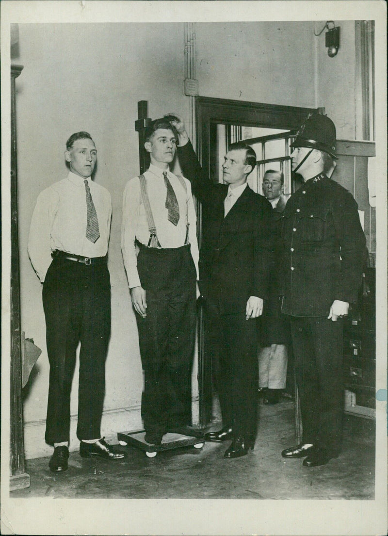 London police officer being measured for height - Vintage Photograph