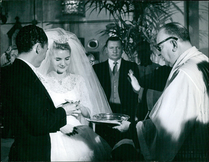 César Giron puts a wedding ring on the finger of his wife Danielle Ricard - Vintage Photograph