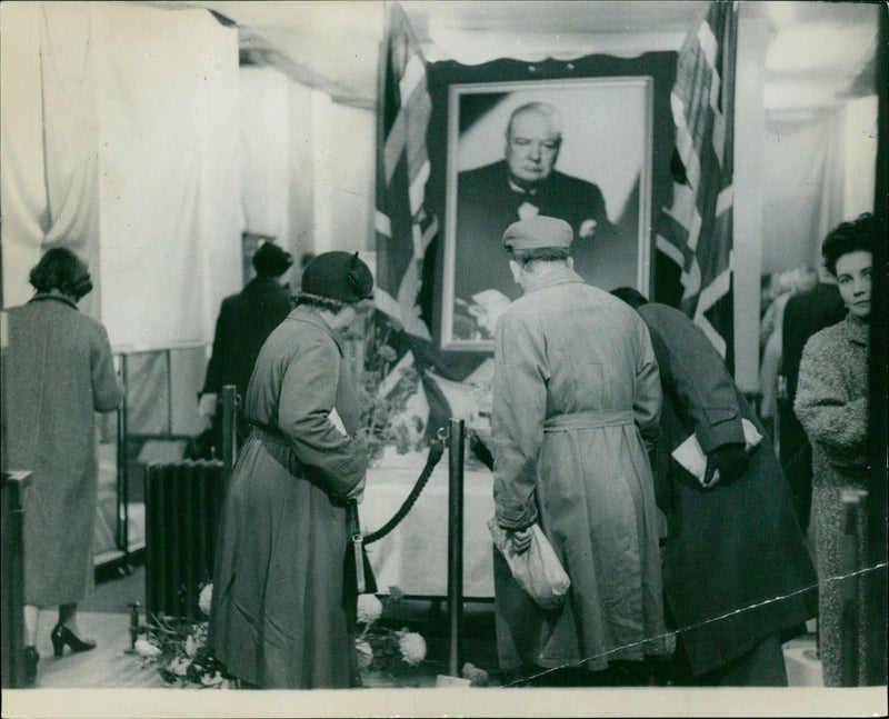 People admiring the birthday cake and big portrait in the Churchill's 80th Birthday Fund exhibition in Piccadilly, London. - Vintage Photograph