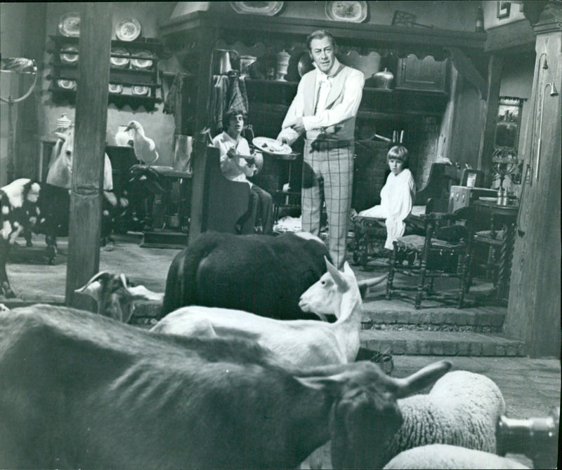 Doctor Dolittle (Rex Harrison) doing "The Reluctant Vegetarian" number in his study. Matthew (Anthony Newley) and Tommy (William Dix) listen along with Dolittle animal friends. - Vintage Photograph