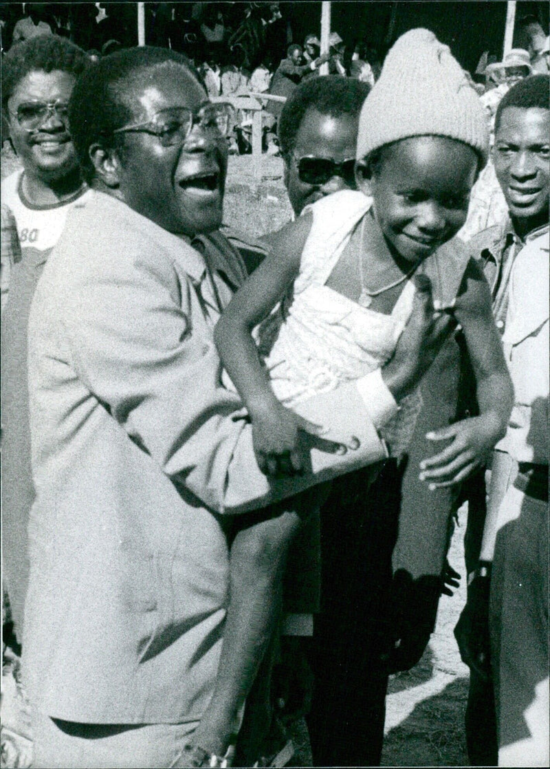 Robert Mugabe interacting with a young fan during a political rally - Vintage Photograph