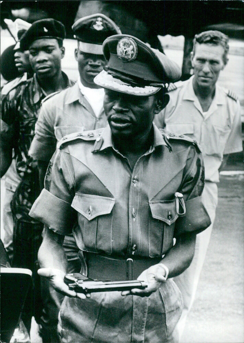 Colonel Benjamin Adekunle, Commander of the Third Marine Commando Division in the Nigerian Army, playing with his revolver - Vintage Photograph