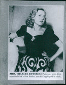 Mrs. Charles Boyer (Pat Paterson) wearing an Adrian model with a velvet bodice and a net skirt appliquéd in black. - Vintage Photograph