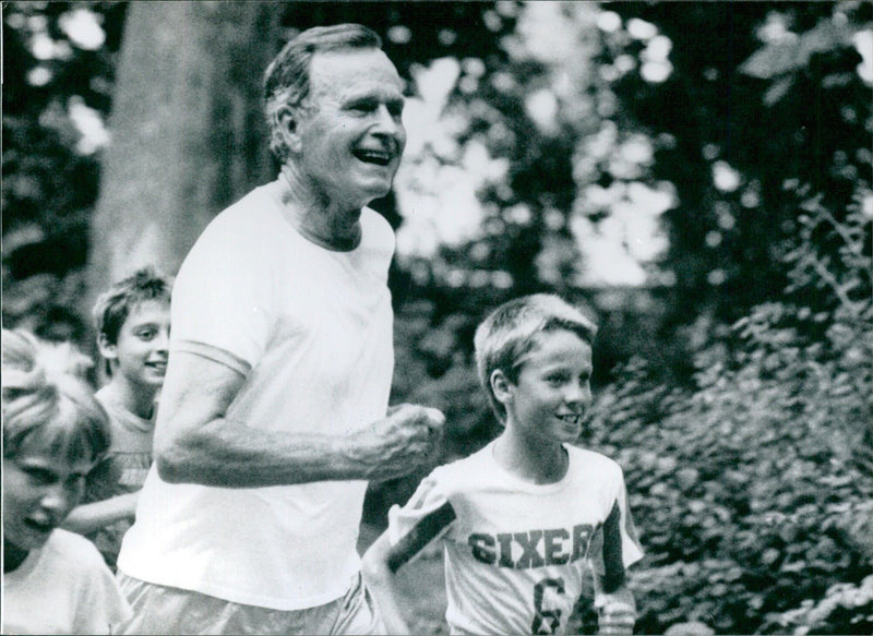 US President George Bush jogging in Lazienki Park, Poland - Vintage Photograph