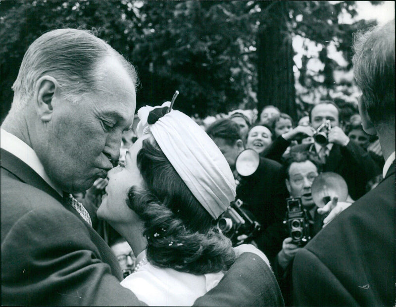 Francoise Arnoul receives a kiss from Maurice Chevalier after the wedding - Vintage Photograph