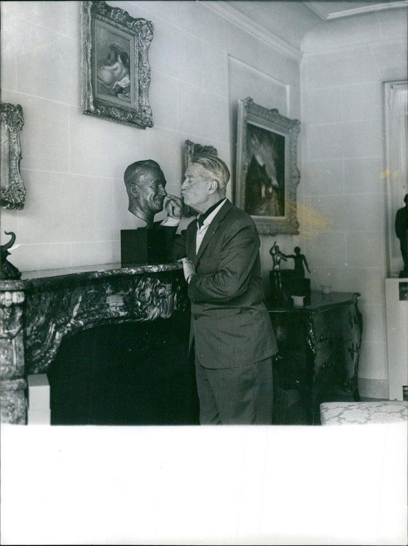 Maurice Chevalier in front of his fireplace - Vintage Photograph