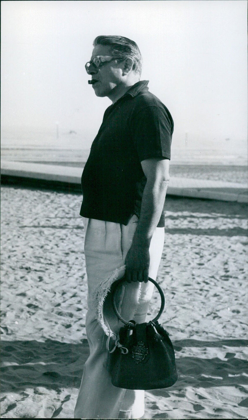 Aristotle Onassis carries his wife's bag at the Venice Film Festival - Vintage Photograph