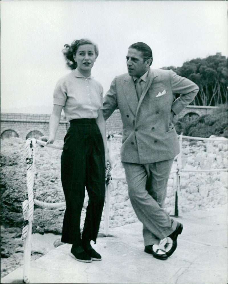 Onassis and his wife Tina Origen Borstelsacker discussing the day's events - Vintage Photograph