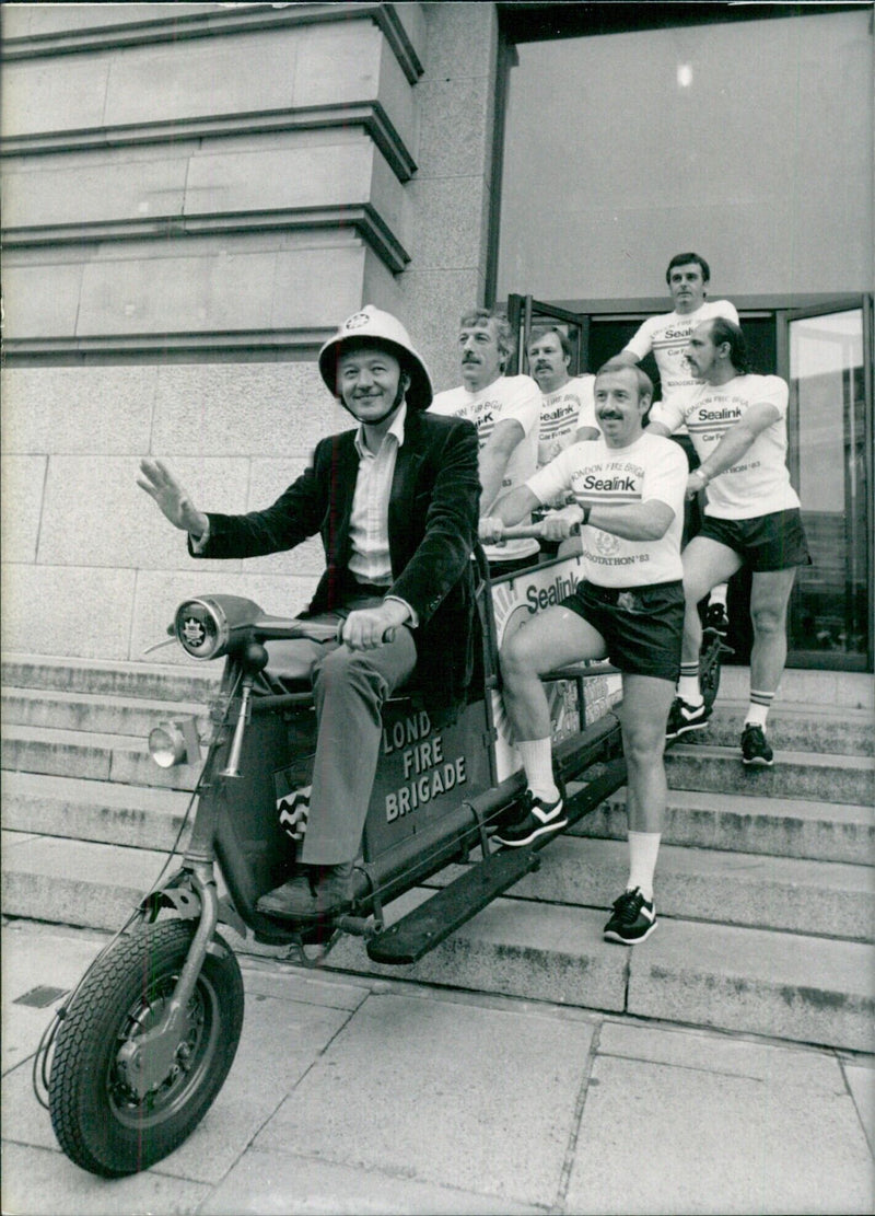 Ken Livingstone, Leader of the Greater London Council (GLC), donning a fireman's helmet at County Hall, London. - Vintage Photograph