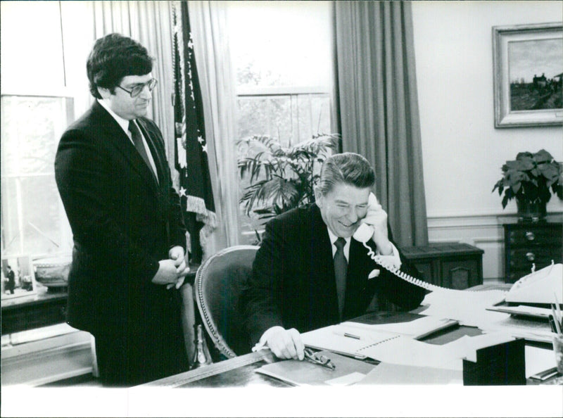 President Reagan receiving a telephone call in the Oval Office - Vintage Photograph